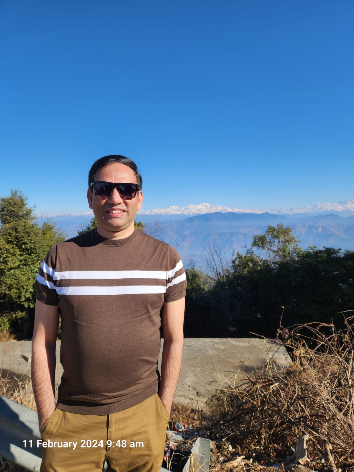 Vikas Sinha enjoying the mountain views near Mangat Farms Kanatal