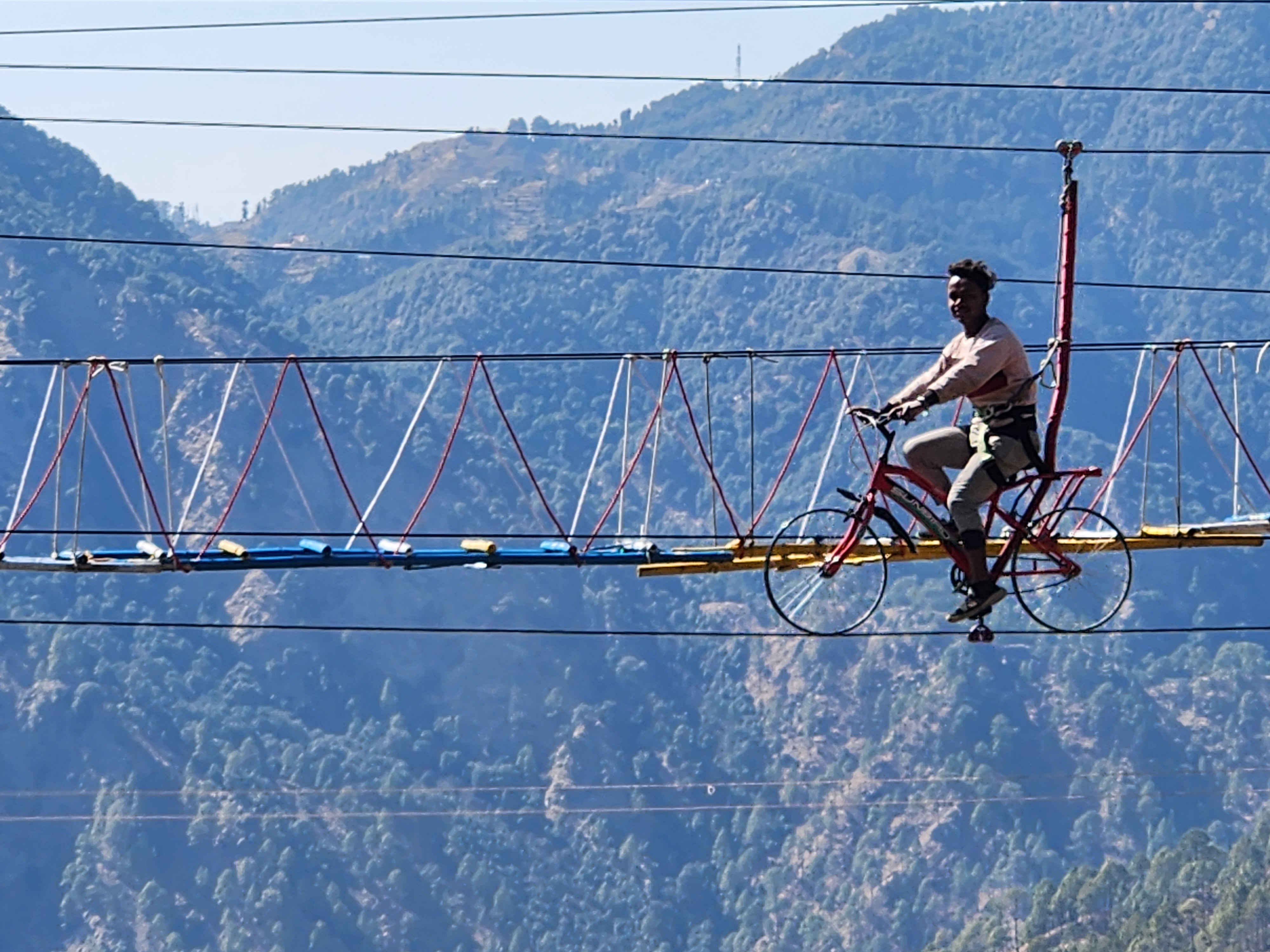 Guest enjoying sky cycling against the Kanatal mountain landscape
